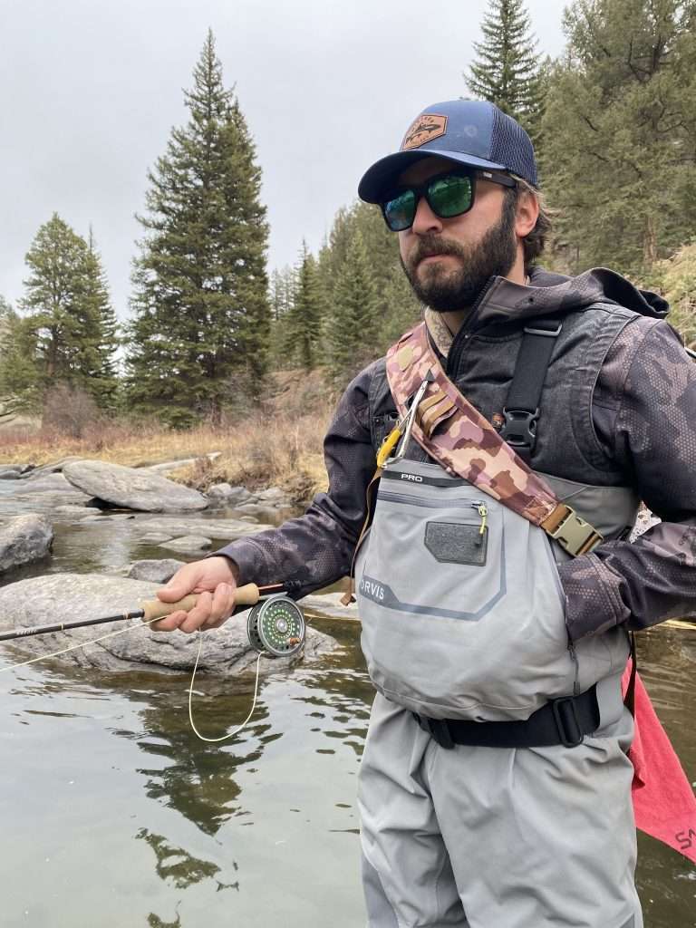 Orvis Pro Wader Review, man fly fishing wearing an Orvis Pro Wader in a natural river