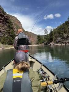 Fishing New Waters - Fly fishing from a drift boat: Part 2, men in a drift boat fly fishing in a natural river with mountains