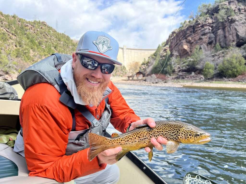 The Orvis Rod Lineup – Not your grandfathers rods anymore, man holding fish in a boat in a river