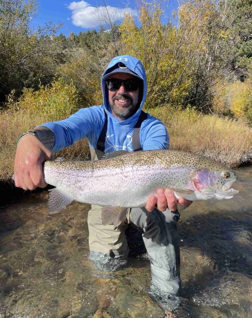 These Fancy Bobbers We Call Indicators, man in blue jacket holding a large fish